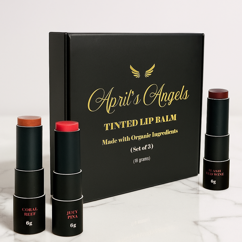 3 Different shades of tinted lip balms formulated with organic ingredients in black and gold eco-friendly packaging with April's Angels golden logo.